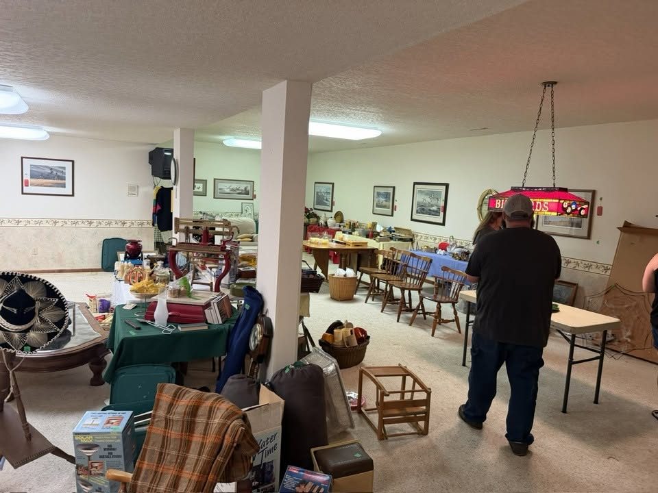 Shoppers browsing tables of household items at a Simple Cleanout estate sale